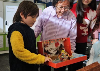 Winner explaining their dragon boat creation